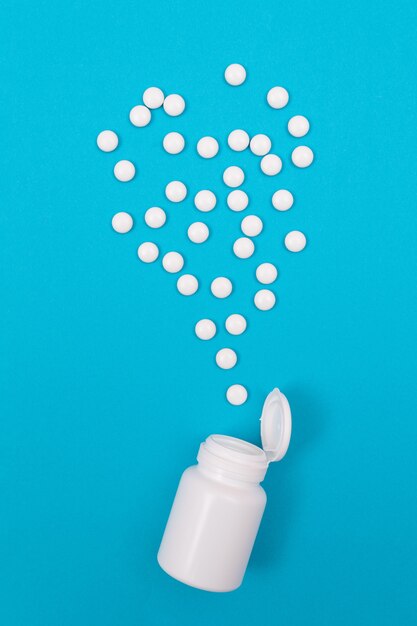 Pharmaceutical industry and medicinal products  white pills on blue background