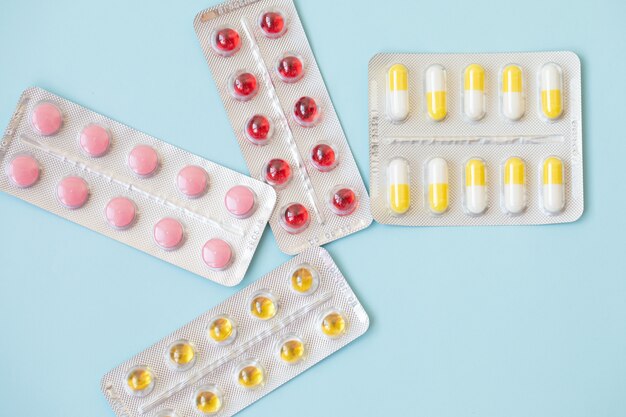 pharmaceuticals antibiotics pills medicine. colorful antibacterials pills on blue. capsule pill medicine