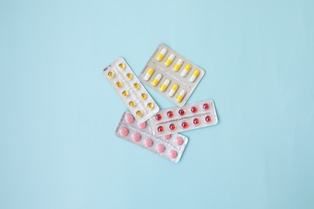 pharmaceuticals antibiotics pills medicine. colorful antibacterials pills on blue. capsule pill medicine