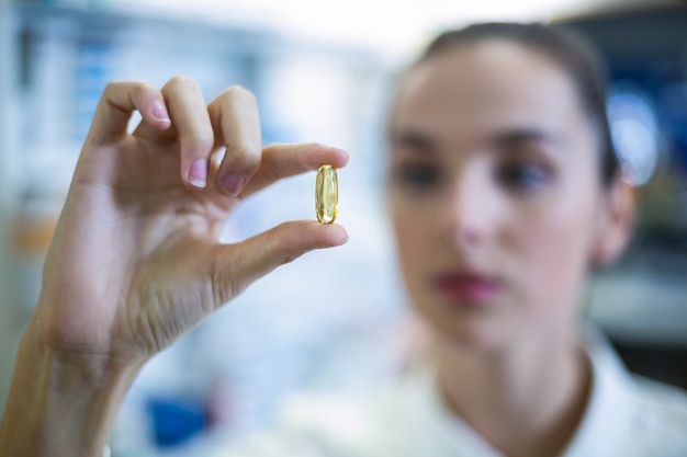 Pharmacist checking a capsule