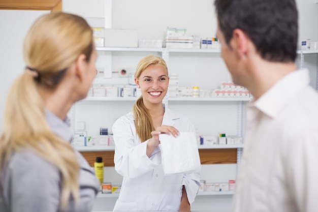 Pharmacist giving a drug bag to patients