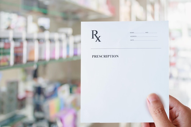 Photo pharmacist hold blank prescription in pharmacy store