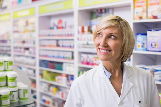 Pharmacist looking up at pharmacy 