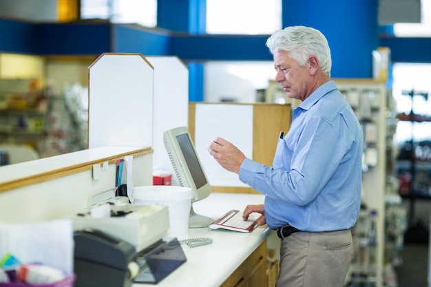 Pharmacist making prescription record through computer