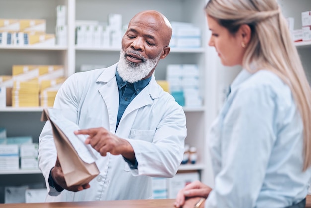 Photo pharmacist medicine and help for woman customer at the counter for pills help and information on treatment pharmacy consulting and girl asking questions from healthcare worker advice and trust