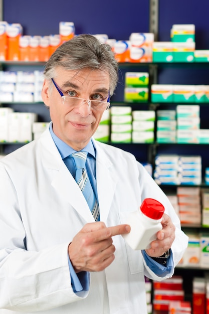 Pharmacist in pharmacy with medicament