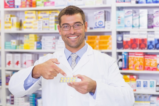 Pharmacist pointing blister packs 