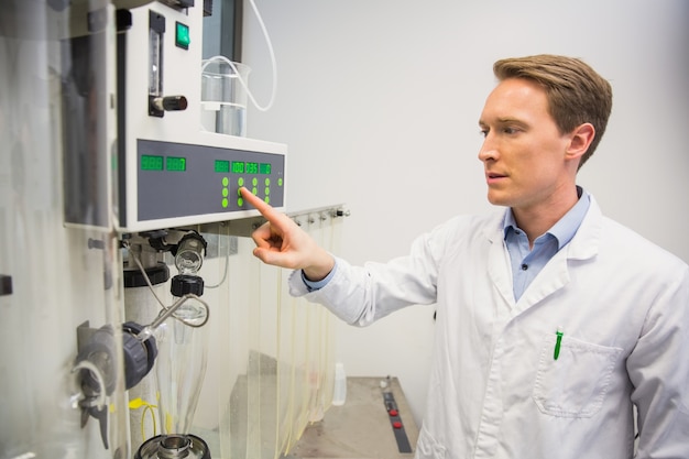 Pharmacist using machinery to make medicine