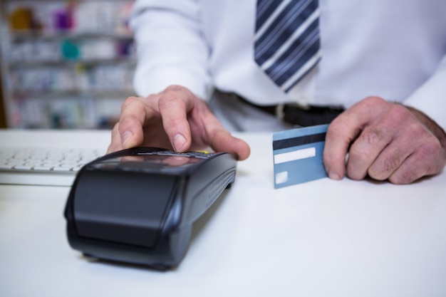 Pharmacist using payment terminal machine