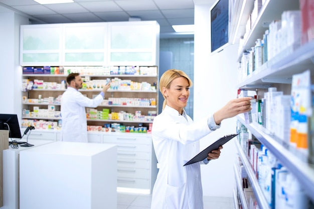 Pharmacists working in pharmacy shop or drugstore.