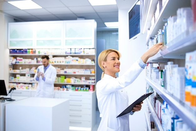 Pharmacists working in pharmacy shop or drugstore.