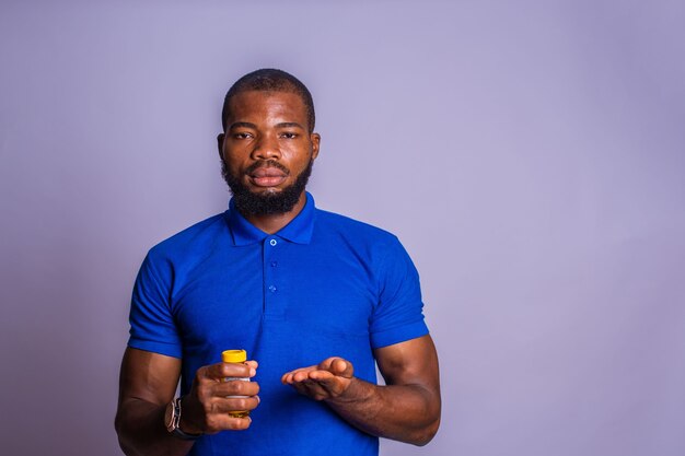 Pharmacy and medical concept, bottle and white pills in the hands of a man on a gray background. Pharmacy and medical concept