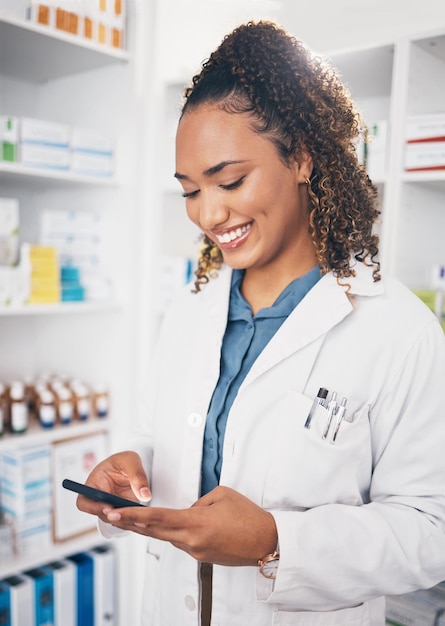 Pharmacy smile and woman with smartphone typing and connection for telehealth social media and chatting Female employee person and pharmacist with cellphone mobile app and texting with network