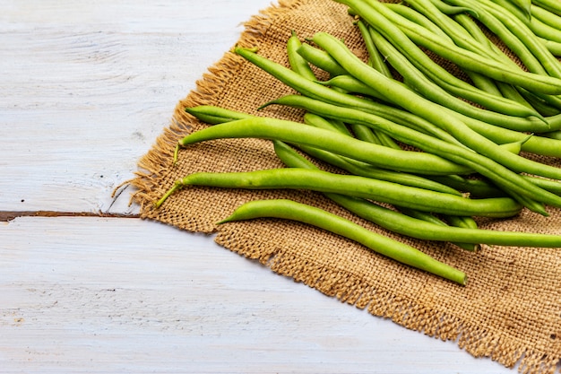 Phaseolus vulgaris, green common bean or kidney bean on rustic sackcloth