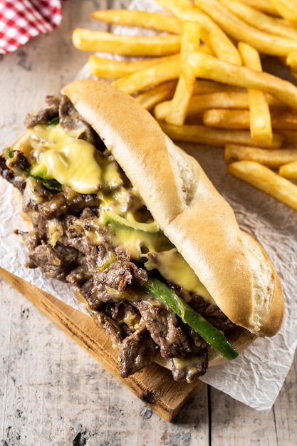 Philly cheesesteak sandwich on wooden table Traditional philadelphia sandwich