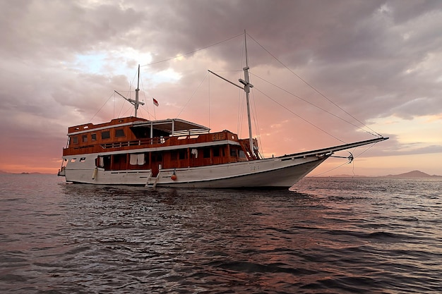 phinisi boat sailing in sunset