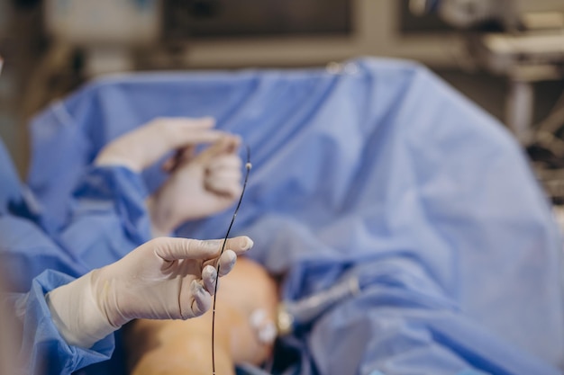 A phlebologist performs an ultrasound of the legs for varicose veins using a modern