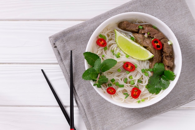 Pho Bo - Vietnamese verse rijstnoedelsoep met rundvlees, kruiden, limoen en chili. Vietnamees nationaal gerecht.