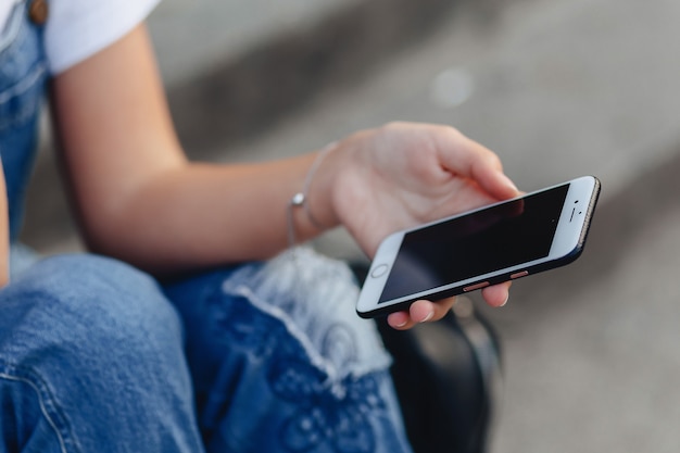 Phone in accurate girls hands with black screen