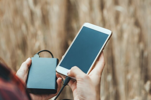 phone and the bank in the hand of a girl