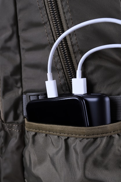 Photo phone charging,powerbank charges smartphone,cellphone with energy bank. depth of field on power bank in the backpack bag