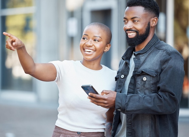 phone city and couple of friends for location search with 5g technology help and happy travel together usa people on smartphone or mobile app and black woman giving direction guide or show street