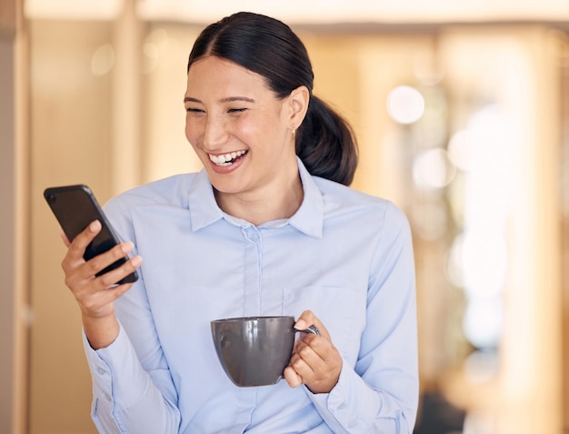 Phone coffee or communication with a business woman networking on social media with a smile while on a break in the office Contact us with 5g mobile technology on the internet with a happy employee