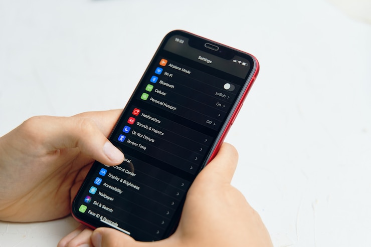 Photo phone in hand. settings phone on screen display.