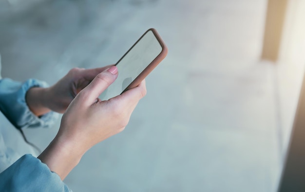 Phone mockup and hands of business person in office for social media internet and mobile space Technology professional and closeup of worker on smartphone for website branding and advertisement