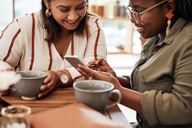 phone review or friends in coffee shop on social media online app or restaurant website for choice reunion tea beverage or women drinking on break for option news or cafe menu order selection
