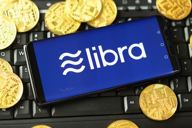 Phone shows Libra logo on the screen.