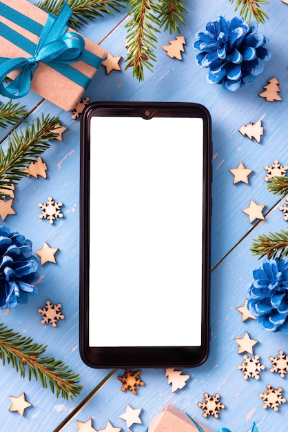 Photo phone on the table at christmas with christmas trees