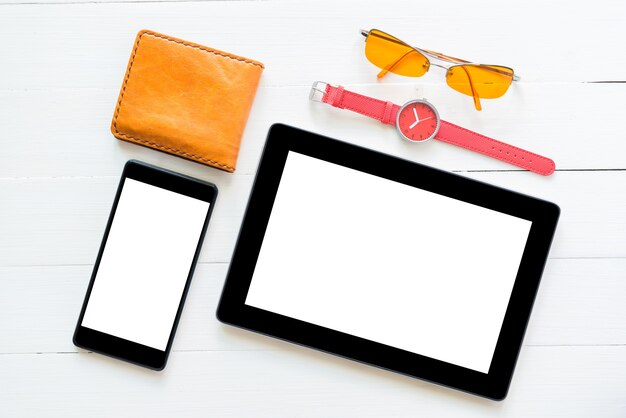 phone and tablet computer on white wood table