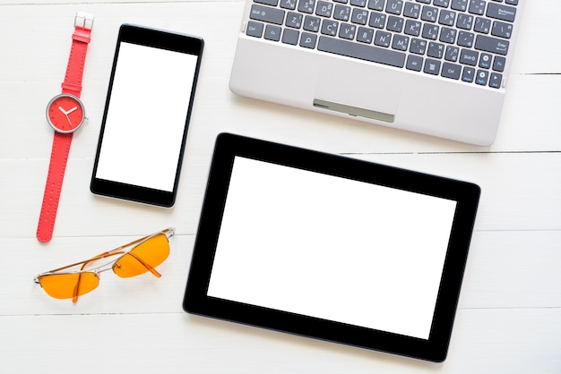 phone and tablet computer on white wood table