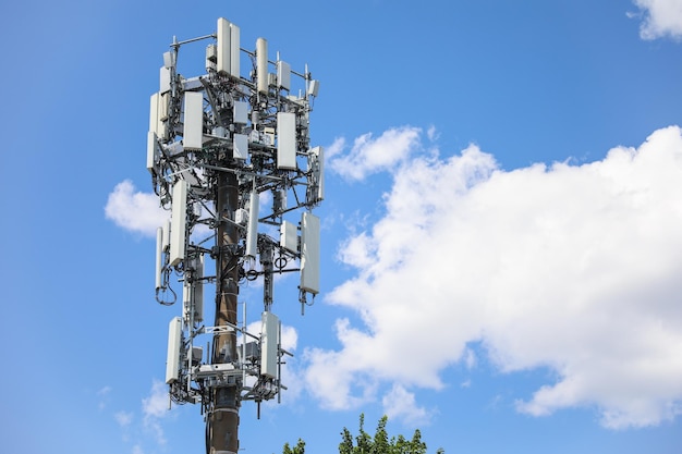 A phone tower with many wires attached to it