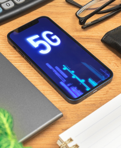 Phone with 5G network, hologram background. Business desktop. Concept photo of high speed internet, new generation of networks