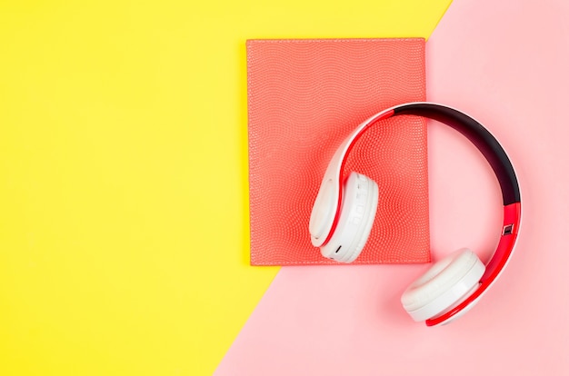 Phone with earphones and book as audiobook concept