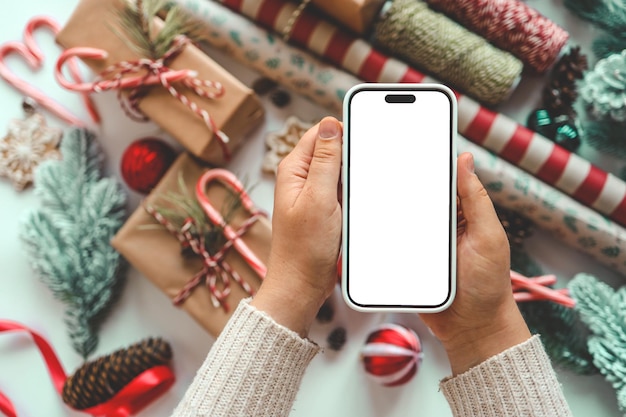Photo phone with isolated screen on background of christmas gifts