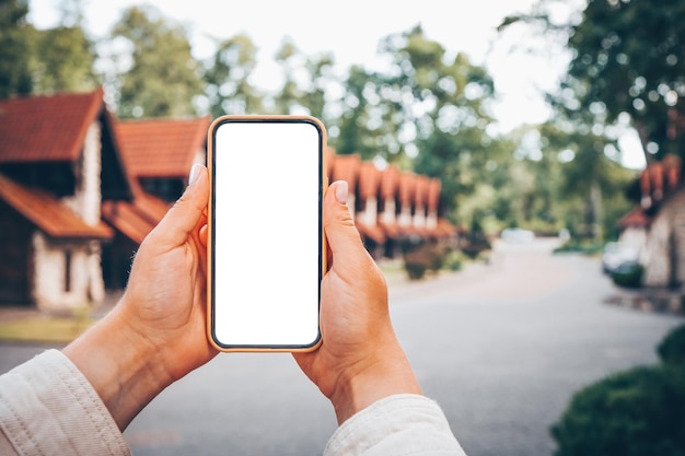 Phone with isolated screen on the background of the cottage