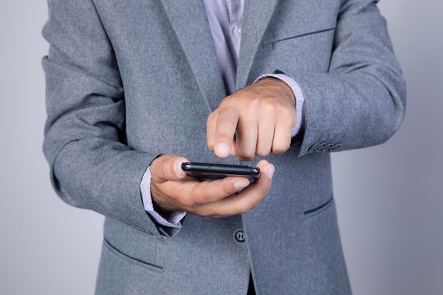 Phonemen hand holding texting using mobile on sofa at home