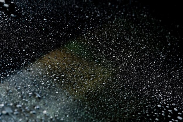 Photo abstraction of ordinary water drops on a reflective mirror