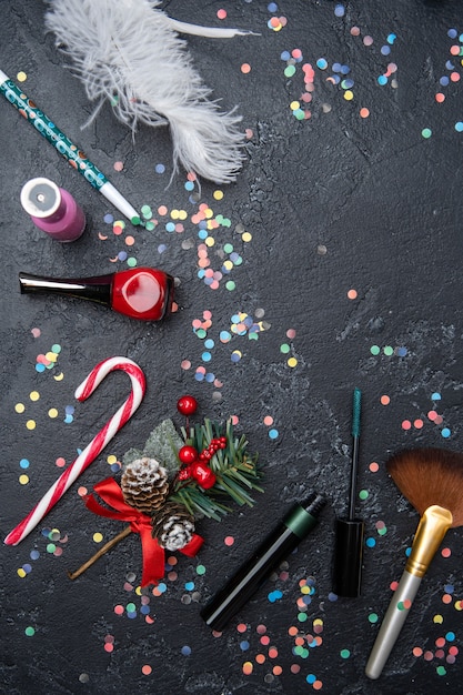 Photo accessories for make-up artist, mandarin, sugar cane on black table with space for text