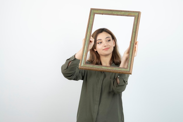 Photo of adorable female model standing in middle of empty frame. High quality photo