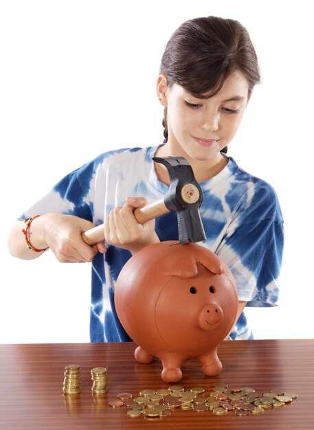 Photo of an adorable girl breaking the money box