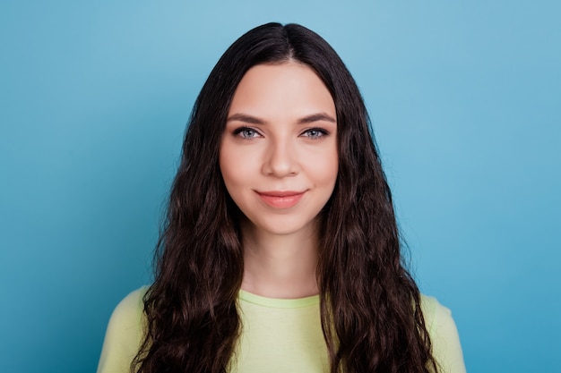 Photo of adorable positive cheerful girl look camera smile enjoy free time on blue background