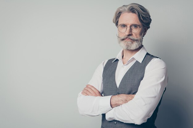 Photo of aged attractive  businessman  standing not smiling serious look arms crossed