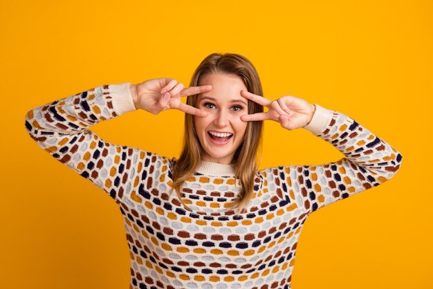 Photo of amazing lady showing vsign symbols near eyes flirty isolated yellow color background