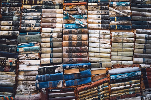 photo of ancient books piled on top of each other Famous bookstore in Venice Libreria Acqua Alta