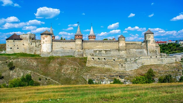 Photo of ancient stone castle with many hight towers in KamyanetsPodilsky