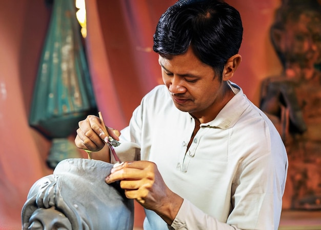 photo of an artist is sculpting a statue realistic style and focused on object
